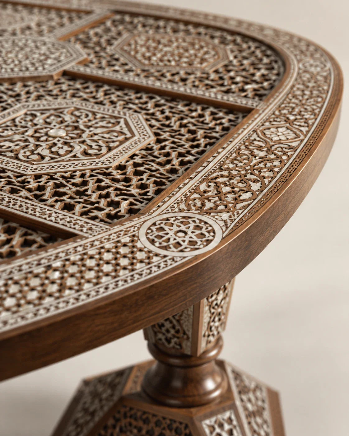 Carved table edge and pedestal with mother-of-pearl geometric inlay